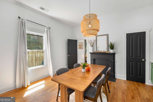 69 Hogue St NE, Atlanta, GA 30312 - dining space with light wood finished floors, baseboards, and crown molding