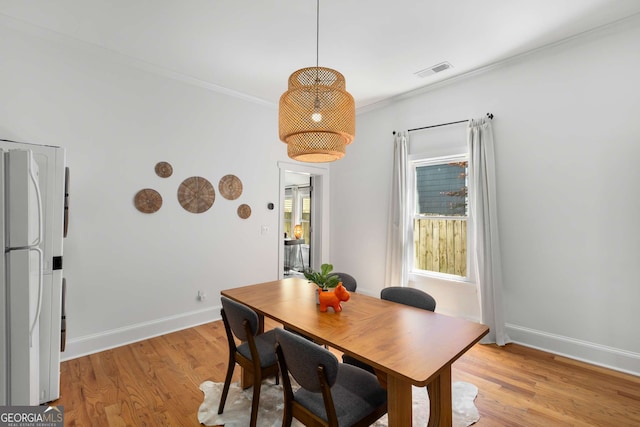 69 Hogue St NE, Atlanta, GA 30312 - dining space with light wood-style flooring, crown molding, and baseboards