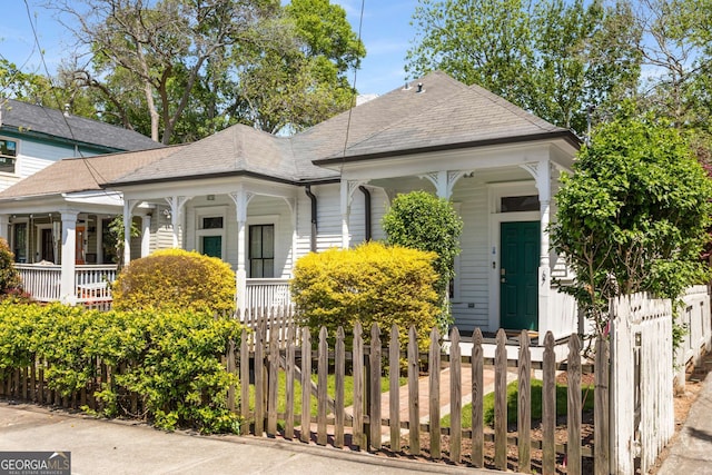 69 Hogue St NE, Atlanta, GA 30312 - shotgun-style home featuring covered porch and a fenced front yard