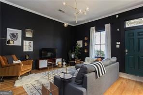 69 Hogue St NE, Atlanta, GA 30312 - living room featuring a chandelier, wood finished floors, and crown molding