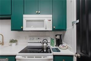 69 Hogue St NE, Atlanta, GA 30312 - kitchen with white appliances, green cabinetry, and light countertops
