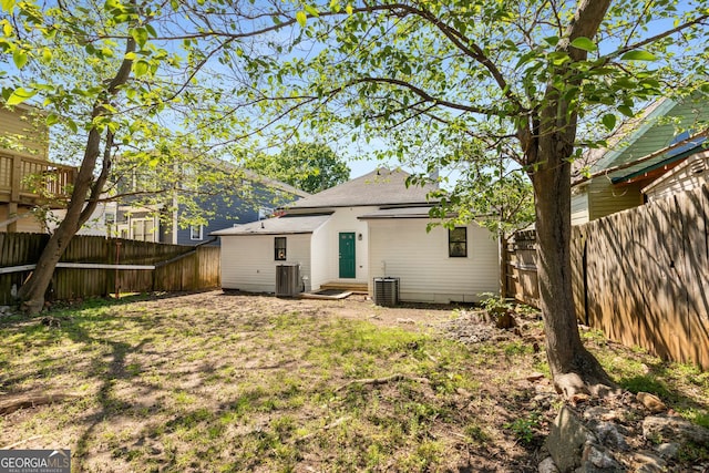 69 Hogue St NE, Atlanta, GA 30312 - back of house featuring central AC, a fenced backyard, and a shingled roof