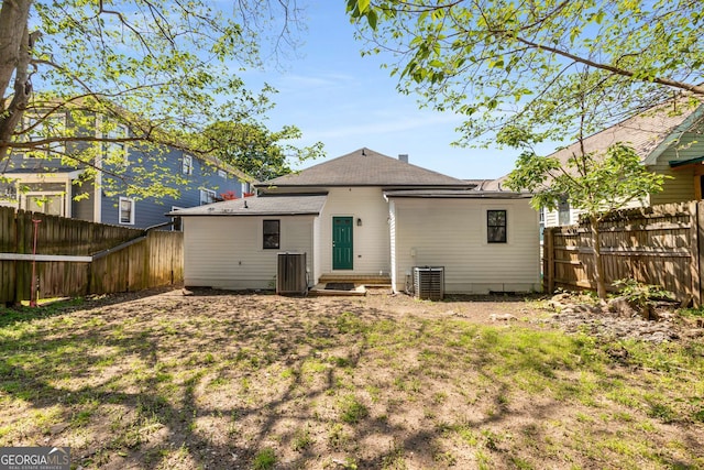 69 Hogue St NE, Atlanta, GA 30312 - back of property featuring a fenced backyard, central air condition unit, and roof with shingles