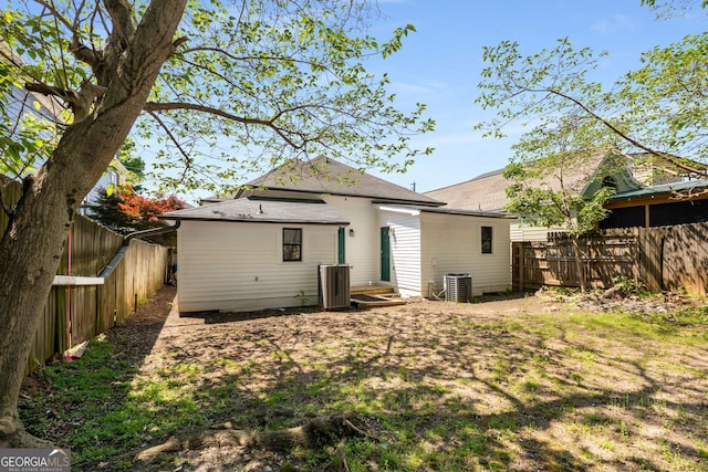 69 Hogue St NE, Atlanta, GA 30312 - rear view of house featuring a fenced backyard, cooling unit, and roof with shingles