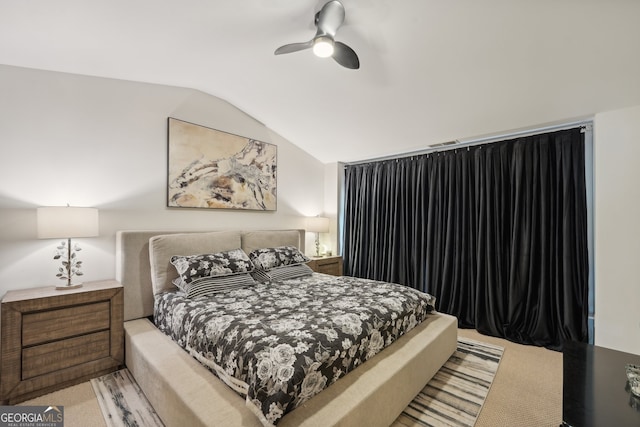 carpeted bedroom with lofted ceiling, visible vents, and a ceiling fan
