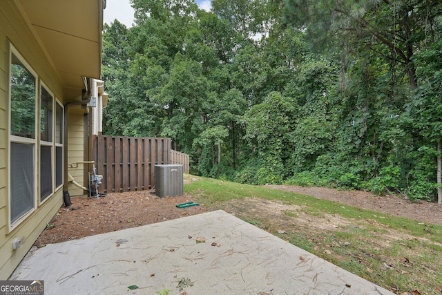 view of yard with central AC and a patio area