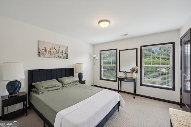 bedroom with light carpet, baseboards, and visible vents