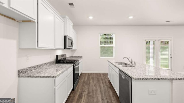 1416 Clear Pond Ln, Dacula, GA 30019 - kitchen with appliances with stainless steel finishes, a sink, white cabinetry, dark wood-style floors, and an island with sink