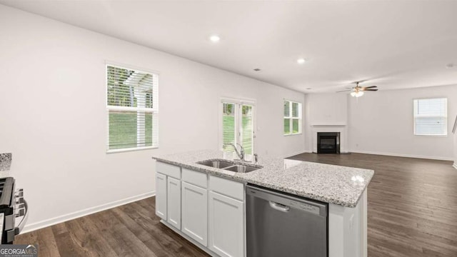 1416 Clear Pond Ln, Dacula, GA 30019 - kitchen with appliances with stainless steel finishes, a sink, a fireplace, white cabinetry, and dark wood-type flooring