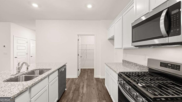1416 Clear Pond Ln, Dacula, GA 30019 - kitchen with stainless steel appliances, a sink, white cabinetry, dark wood-type flooring, and recessed lighting