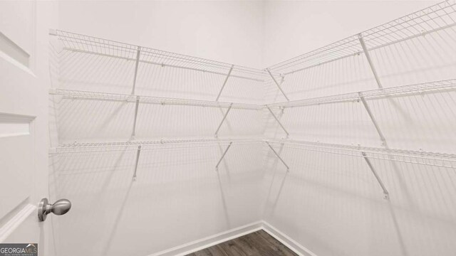 1416 Clear Pond Ln, Dacula, GA 30019 - walk in closet featuring dark wood-style flooring