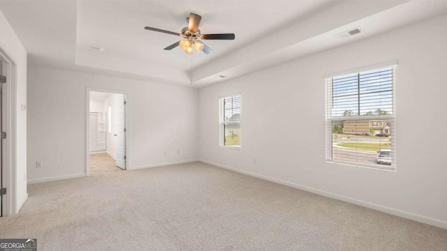 1416 Clear Pond Ln, Dacula, GA 30019 - unfurnished bedroom featuring light carpet, baseboards, a tray ceiling, ceiling fan, and ensuite bath