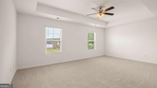 1416 Clear Pond Ln, Dacula, GA 30019 - unfurnished room featuring a raised ceiling, light colored carpet, baseboards, and ceiling fan