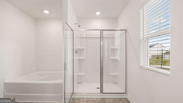 1416 Clear Pond Ln, Dacula, GA 30019 - full bath featuring a stall shower, a garden tub, and baseboards