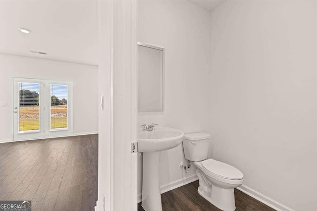 1416 Clear Pond Ln, Dacula, GA 30019 - bathroom featuring baseboards, hardwood / wood-style flooring, and toilet