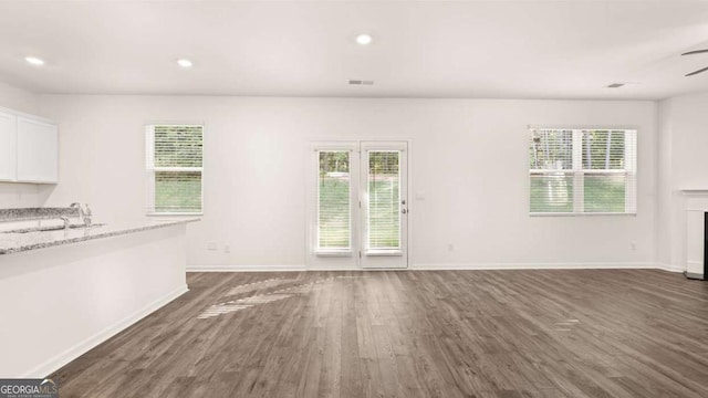 1416 Clear Pond Ln, Dacula, GA 30019 - unfurnished living room with dark wood-style flooring, baseboards, a sink, ceiling fan, and recessed lighting