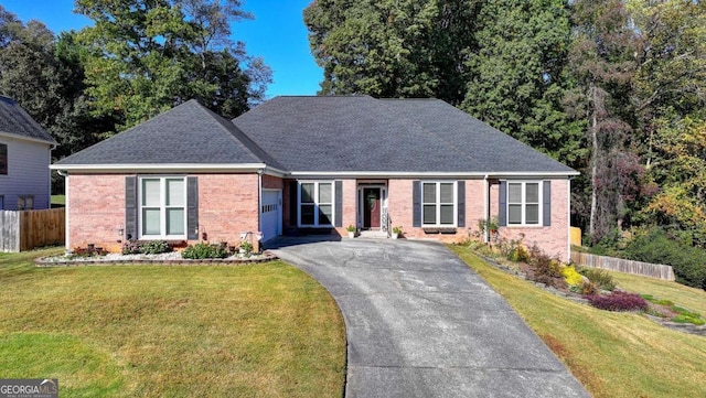2820 Ashton Tree Ct, Dacula, GA 30019 - view of front of house with a garage, driveway, fence, a front yard, and brick siding