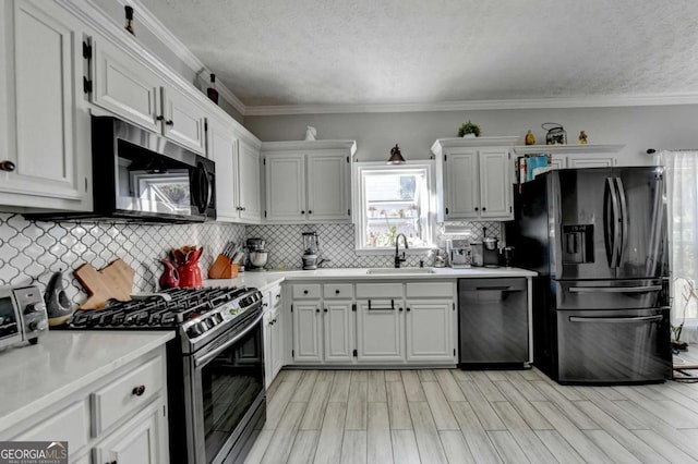 2820 Ashton Tree Ct, Dacula, GA 30019 - kitchen with white cabinets, light countertops, a sink, and appliances with stainless steel finishes