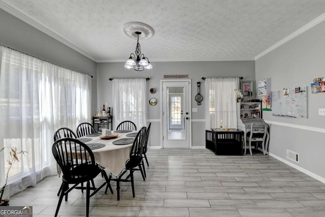 2820 Ashton Tree Ct, Dacula, GA 30019 - dining area with crown molding, a textured ceiling, baseboards, a notable chandelier, and visible vents