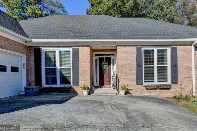 2820 Ashton Tree Ct, Dacula, GA 30019 - view of front of house featuring an attached garage, brick siding, and a shingled roof