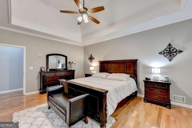 2820 Ashton Tree Ct, Dacula, GA 30019 - bedroom with a raised ceiling, baseboards, visible vents, light wood-style floors, and ornamental molding