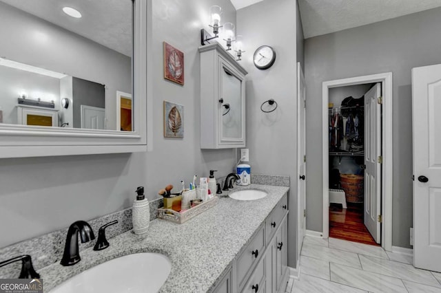 2820 Ashton Tree Ct, Dacula, GA 30019 - bathroom featuring a spacious closet, marble finish floor, a sink, and double vanity