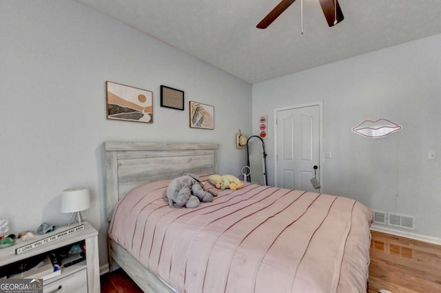2820 Ashton Tree Ct, Dacula, GA 30019 - bedroom with wood finished floors, visible vents, a ceiling fan, and baseboards
