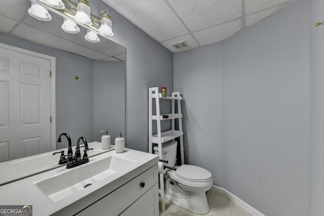 2820 Ashton Tree Ct, Dacula, GA 30019 - half bathroom featuring toilet, a drop ceiling, visible vents, tile patterned flooring, and vanity