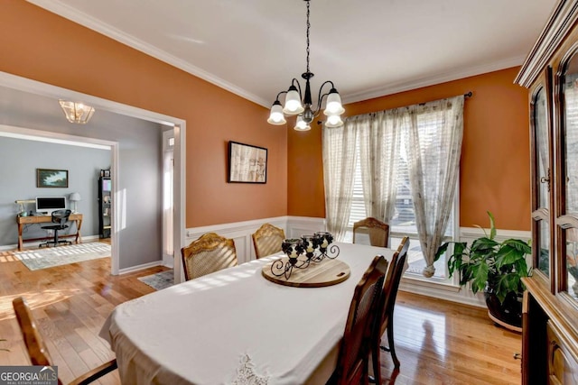 2820 Ashton Tree Ct, Dacula, GA 30019 - dining space with a chandelier, light wood-style floors, crown molding, and wainscoting