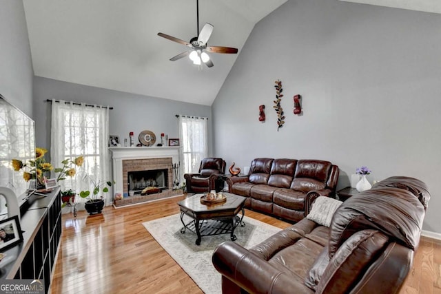 2820 Ashton Tree Ct, Dacula, GA 30019 - living area with wood finished floors, a brick fireplace, a ceiling fan, and high vaulted ceiling