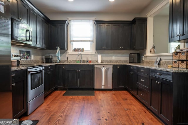 15 Chestnut Oak Run, Athens, GA 30607 - kitchen featuring recessed lighting, light wood finished floors, a sink, light stone countertops, and appliances with stainless steel finishes