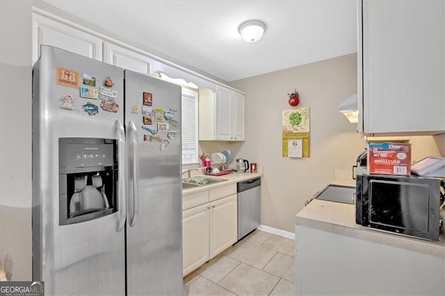 992 Old Holcomb Bridge Rd, Roswell, GA 30076 - kitchen featuring stainless steel appliances, light countertops, a sink, light tile patterned flooring, and wall chimney exhaust hood