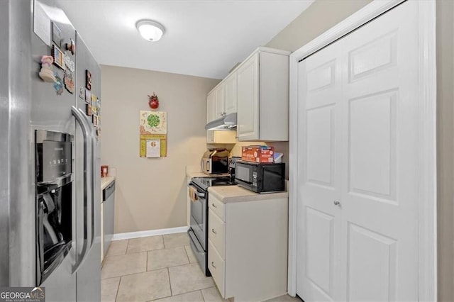 992 Old Holcomb Bridge Rd, Roswell, GA 30076 - kitchen with white cabinets, light tile patterned flooring, light countertops, under cabinet range hood, and appliances with stainless steel finishes