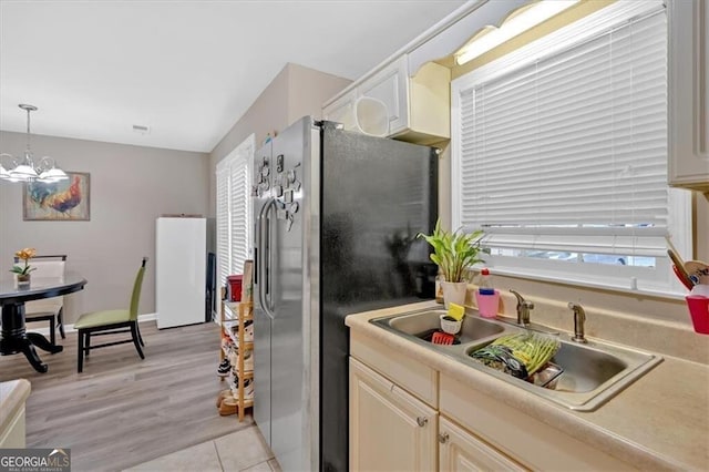 992 Old Holcomb Bridge Rd, Roswell, GA 30076 - kitchen with a sink, stainless steel fridge, light countertops, decorative light fixtures, and freestanding refrigerator