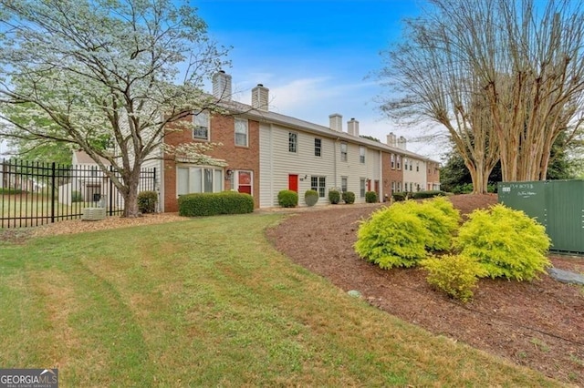 992 Old Holcomb Bridge Rd, Roswell, GA 30076 - back of house featuring a yard, a chimney, and fence
