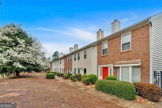 992 Old Holcomb Bridge Rd, Roswell, GA 30076 - exterior space with brick siding and a chimney
