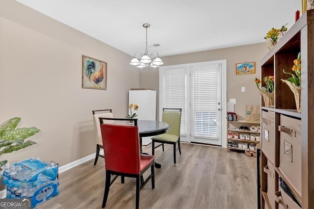 992 Old Holcomb Bridge Rd, Roswell, GA 30076 - dining room with visible vents, baseboards, wood finished floors, and an inviting chandelier