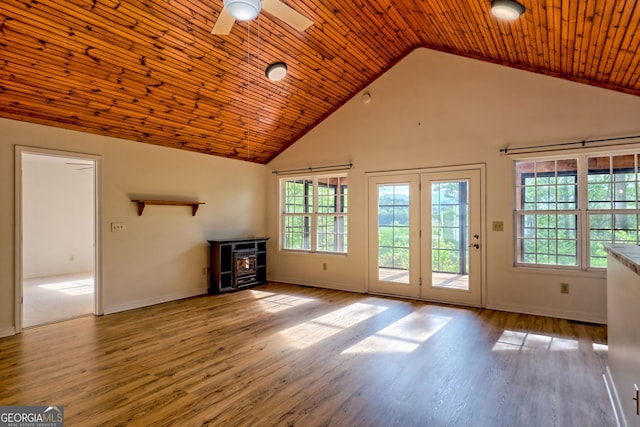 unfurnished living room with high vaulted ceiling, ceiling fan, a healthy amount of sunlight, and wood finished floors