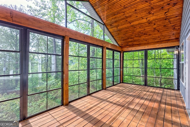 unfurnished sunroom with high vaulted ceiling, wood ceiling, and hardwood / wood-style flooring
