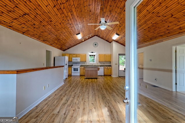 kitchen with ceiling fan, a kitchen island, white appliances, and light wood-style flooring