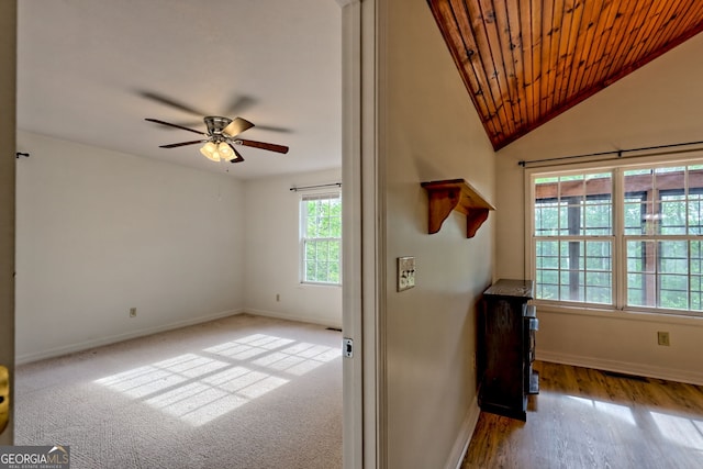 interior space with wooden ceiling, baseboards, ceiling fan, and wood finished floors