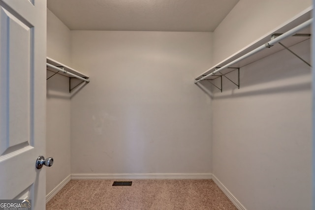 walk in closet featuring carpet flooring and visible vents