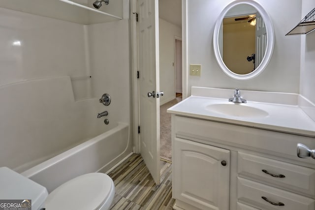 bathroom with toilet, ceiling fan, bathtub / shower combination, and vanity