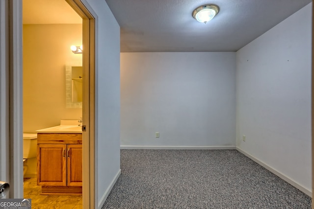 carpeted empty room with baseboards