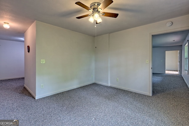 spare room featuring carpet floors, baseboards, and ceiling fan