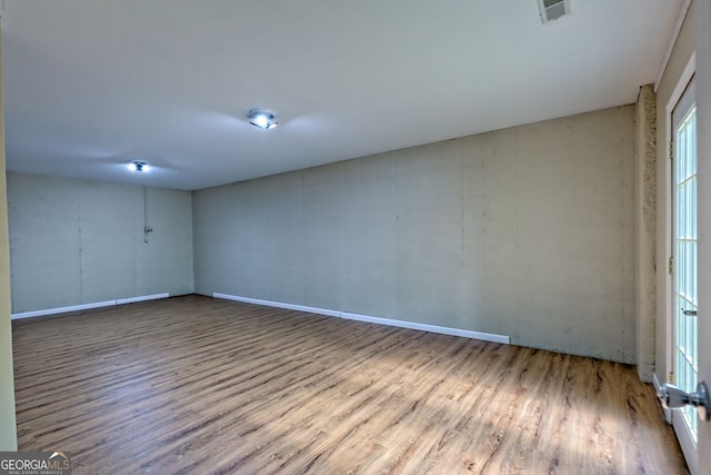 spare room featuring visible vents and wood finished floors