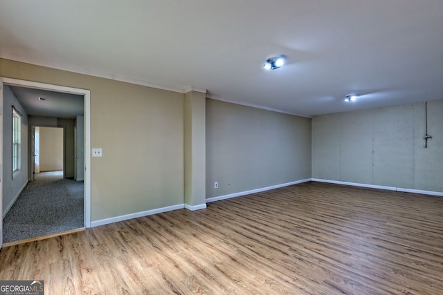 empty room featuring baseboards and wood finished floors