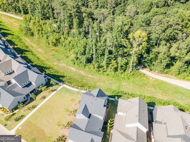 birds eye view of property with a residential view and a view of trees