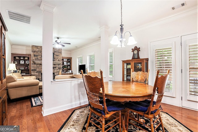 dining area with crown molding, visible vents, and wood finished floors
