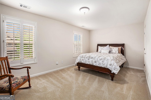 bedroom featuring visible vents, baseboards, and carpet floors